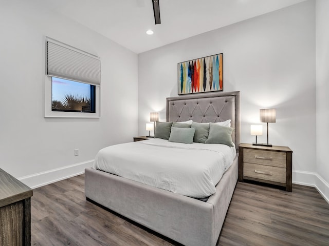 bedroom with ceiling fan and dark wood-type flooring