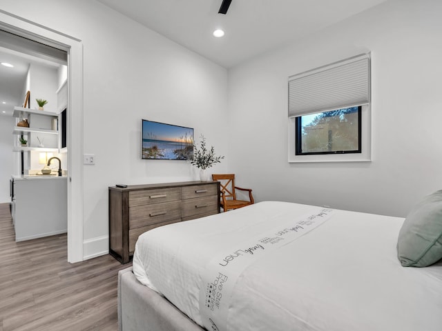 bedroom with light wood-type flooring and ceiling fan