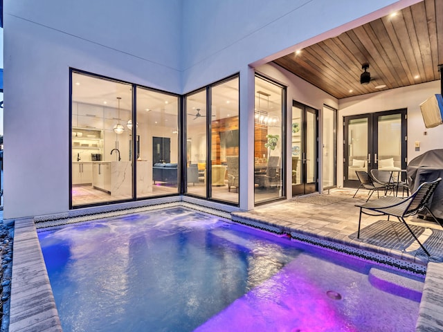 view of pool with a patio and ceiling fan