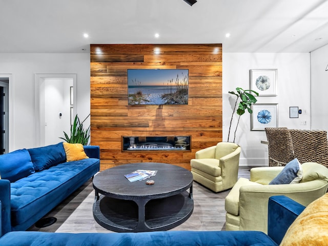 living room with wood-type flooring and wooden walls