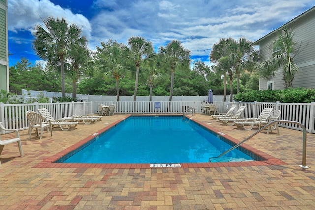 220 N Saint Francis Dr, Miramar Beach, FL 32550 - community pool featuring a patio area and view of wooded area