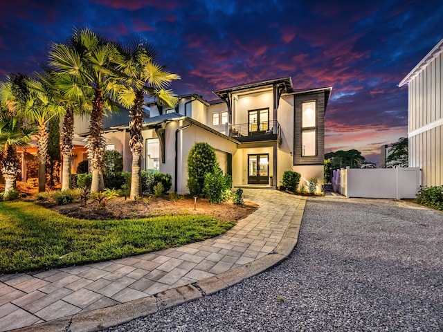 220 N Saint Francis Dr, Miramar Beach, FL 32550 - view of front of property with french doors, a balcony, stucco siding, and driveway