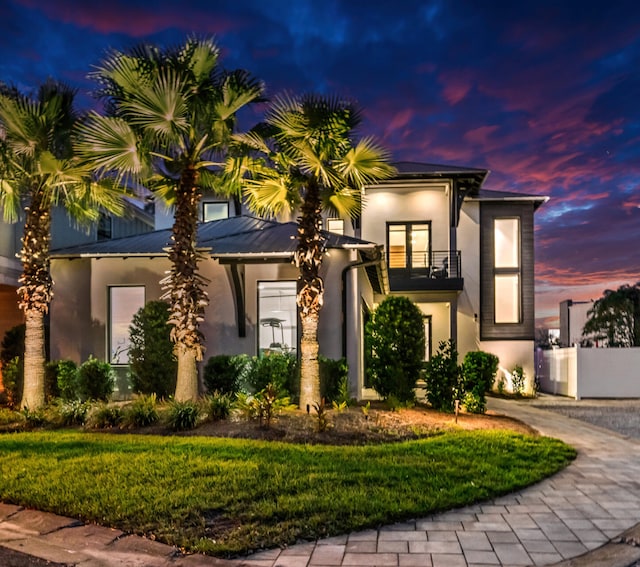 220 N Saint Francis Dr, Miramar Beach, FL 32550 - view of front of house featuring a balcony, stucco siding, and a front yard