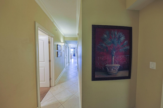 corridor with crown molding and light tile patterned floors