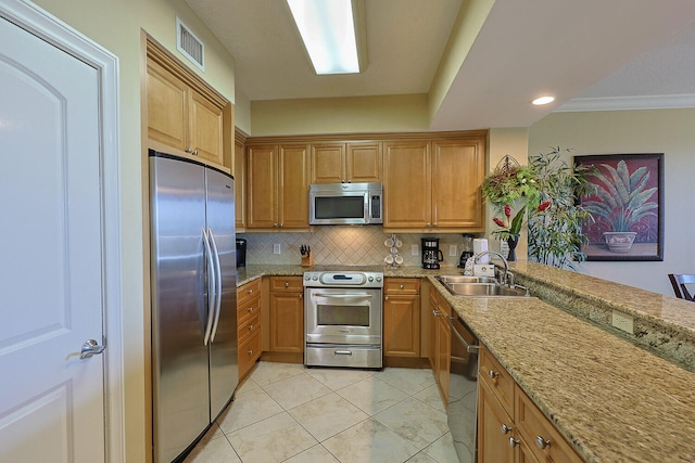 kitchen with tasteful backsplash, light stone countertops, sink, stainless steel appliances, and ornamental molding