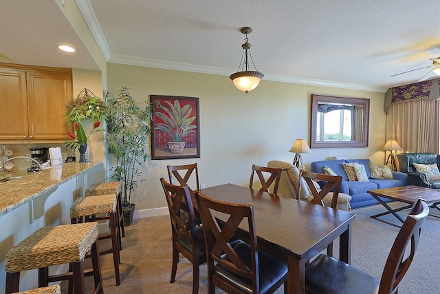 dining space with carpet, crown molding, a textured ceiling, and ceiling fan