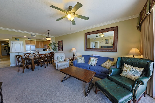 carpeted living room featuring ornamental molding, a textured ceiling, and ceiling fan