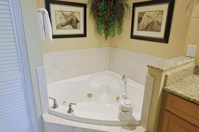 bathroom with vanity and a relaxing tiled tub