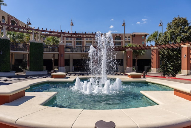 view of pool featuring pool water feature and a pergola