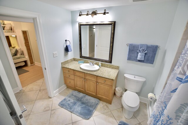 1150 Santa Rosa Blvd Unit 117, Fort Walton Beach, FL 32548 - full bath with vanity, toilet, tile patterned flooring, and baseboards