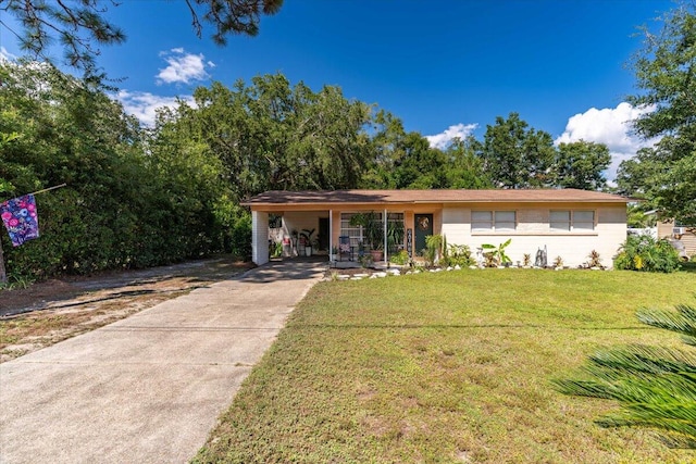 view of front of property with a carport and a front yard