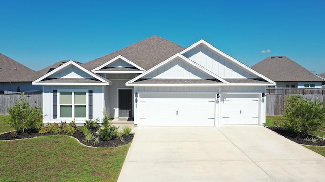 view of front of property with a garage and a front lawn