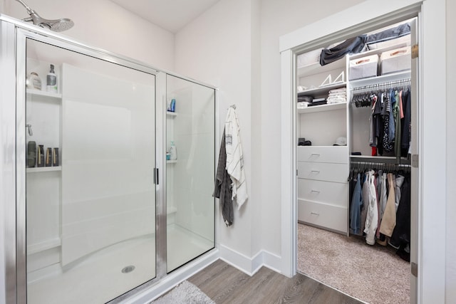 bathroom featuring hardwood / wood-style floors and a shower with shower door