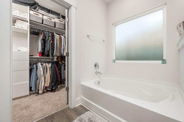 bathroom featuring hardwood / wood-style flooring and a tub