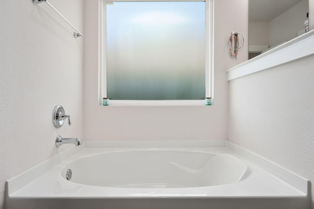 bathroom featuring a tub to relax in