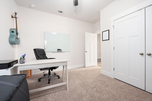 carpeted office space with ceiling fan