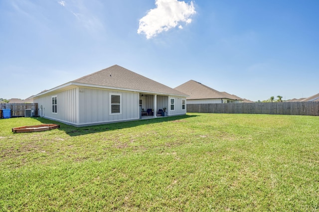 back of house featuring a yard, central AC unit, and a patio area