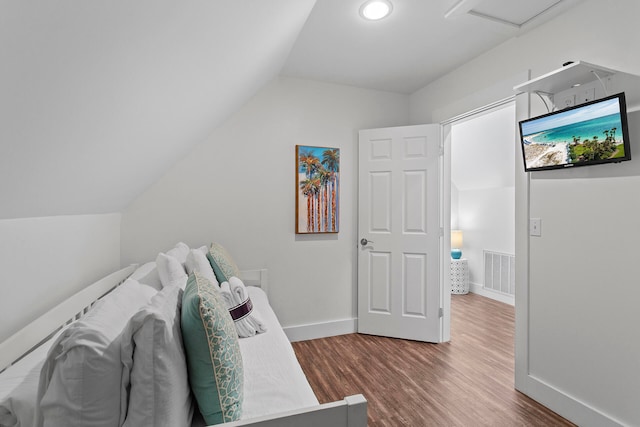 interior space with lofted ceiling and hardwood / wood-style flooring