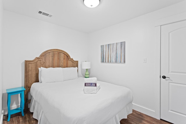 bedroom featuring dark hardwood / wood-style flooring