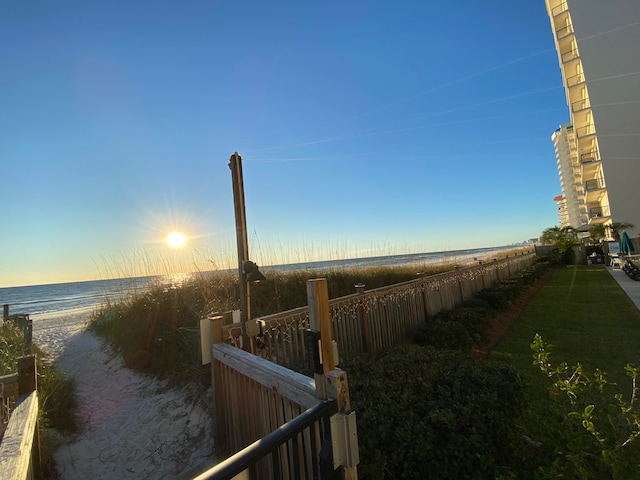 surrounding community featuring a water view and a beach view