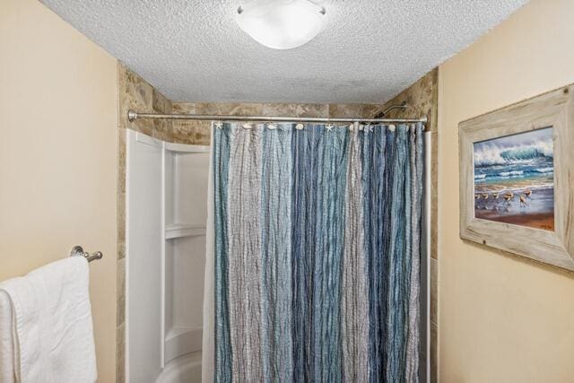 bathroom featuring a textured ceiling and shower / tub combo