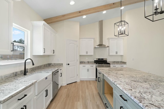 kitchen featuring white cabinetry, wall chimney exhaust hood, stainless steel appliances, light hardwood / wood-style flooring, and decorative light fixtures