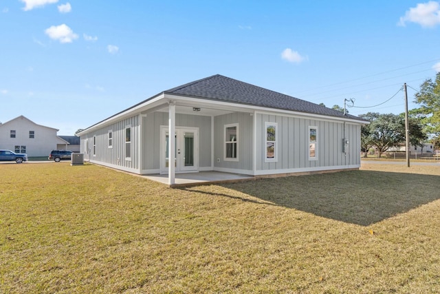 rear view of property with a patio and a lawn