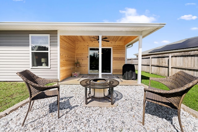 view of patio / terrace with ceiling fan and an outdoor fire pit