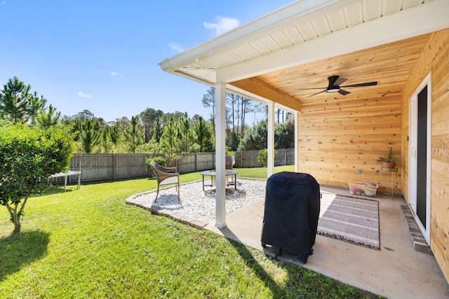 view of yard with a trampoline, a patio area, and ceiling fan