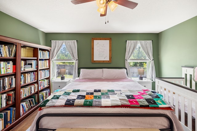 bedroom with wood-type flooring and ceiling fan