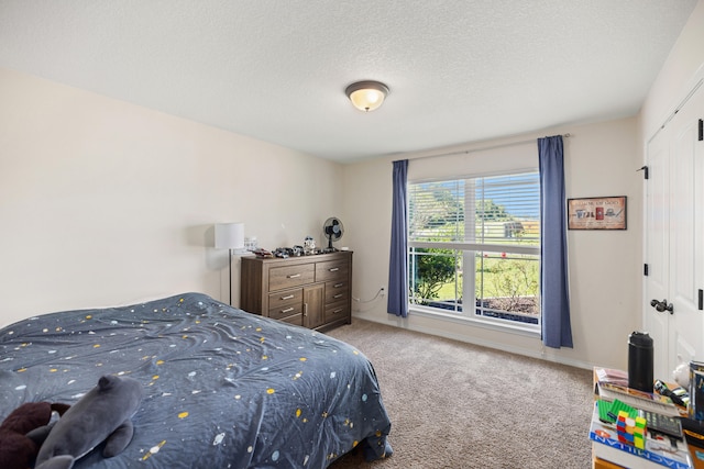 carpeted bedroom featuring a textured ceiling