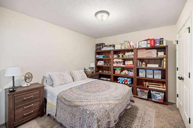 carpeted bedroom featuring a textured ceiling