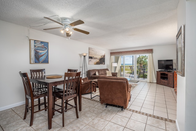 dining area featuring ceiling fan, a textured ceiling, and light tile patterned floors