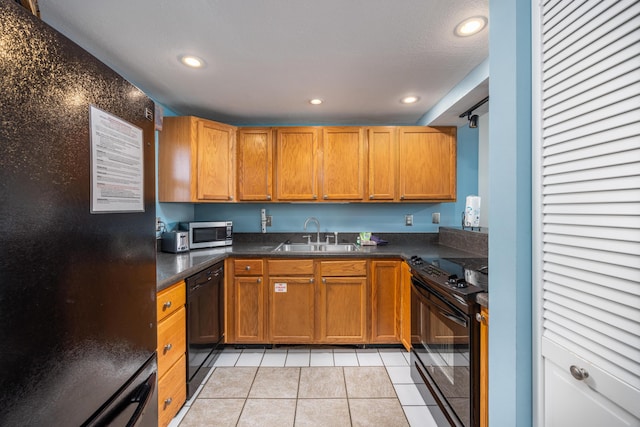 kitchen featuring recessed lighting, a sink, light tile patterned flooring, black appliances, and dark countertops