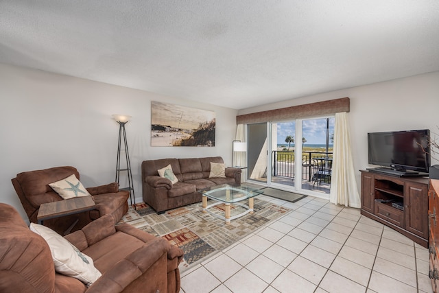 tiled living room featuring a textured ceiling