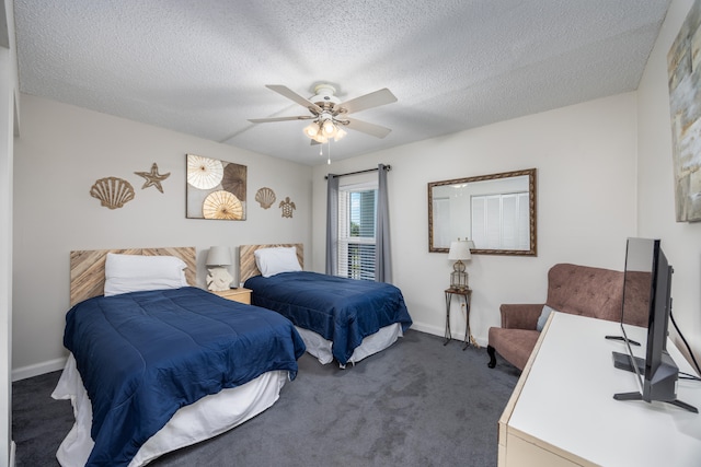 carpeted bedroom featuring a textured ceiling and ceiling fan