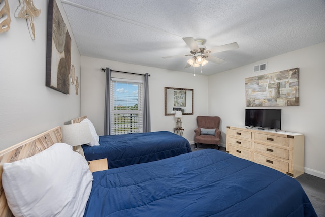 bedroom featuring a textured ceiling and ceiling fan