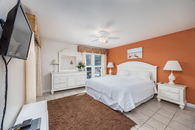 bedroom with baseboards, ceiling fan, and tile patterned flooring