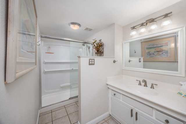 bathroom with tile patterned flooring, a shower with door, and vanity