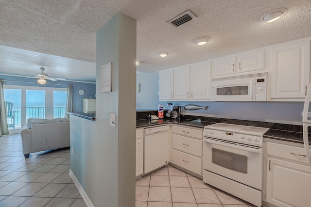 kitchen featuring ceiling fan, light tile patterned floors, white appliances, a textured ceiling, and white cabinetry