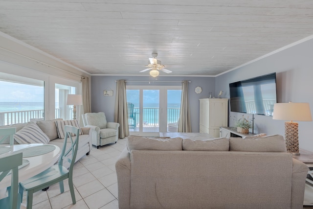 living room with a healthy amount of sunlight, a water view, crown molding, and ceiling fan