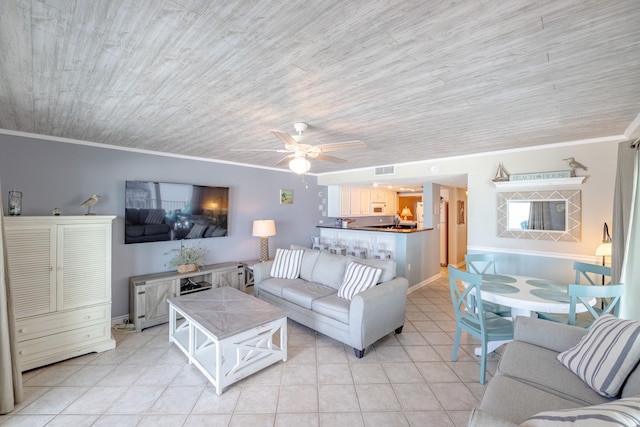 tiled living room featuring crown molding and ceiling fan