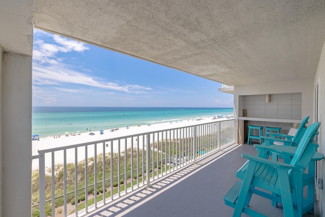 balcony with a view of the beach and a water view