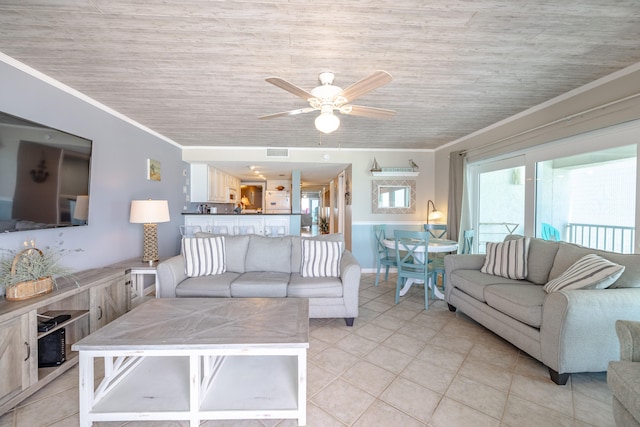 tiled living room featuring crown molding and ceiling fan