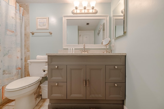 bathroom with tile patterned flooring, curtained shower, vanity, and toilet