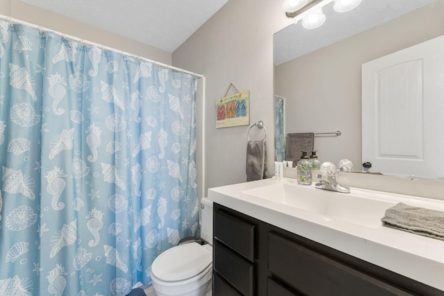 bathroom with a textured ceiling, vanity, toilet, and a shower with shower curtain