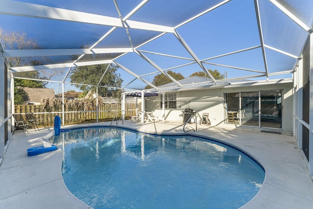 view of swimming pool with a lanai and a patio area