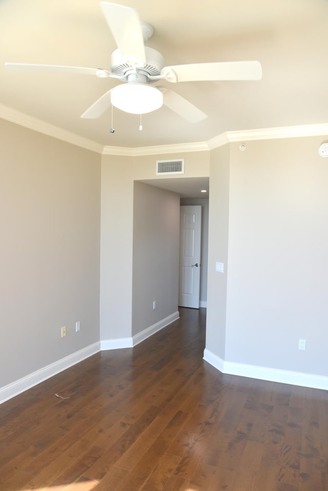 unfurnished room featuring dark hardwood / wood-style floors, crown molding, and ceiling fan