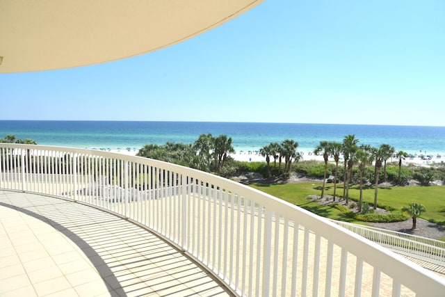 balcony featuring a water view and a beach view