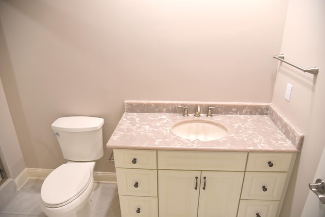 bathroom featuring tile patterned floors, toilet, and vanity